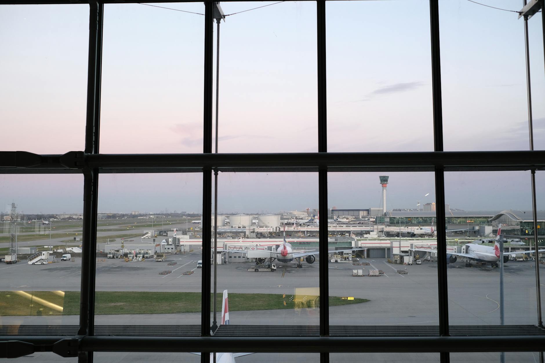 Modern airport terminal interior with passengers and flight information displays