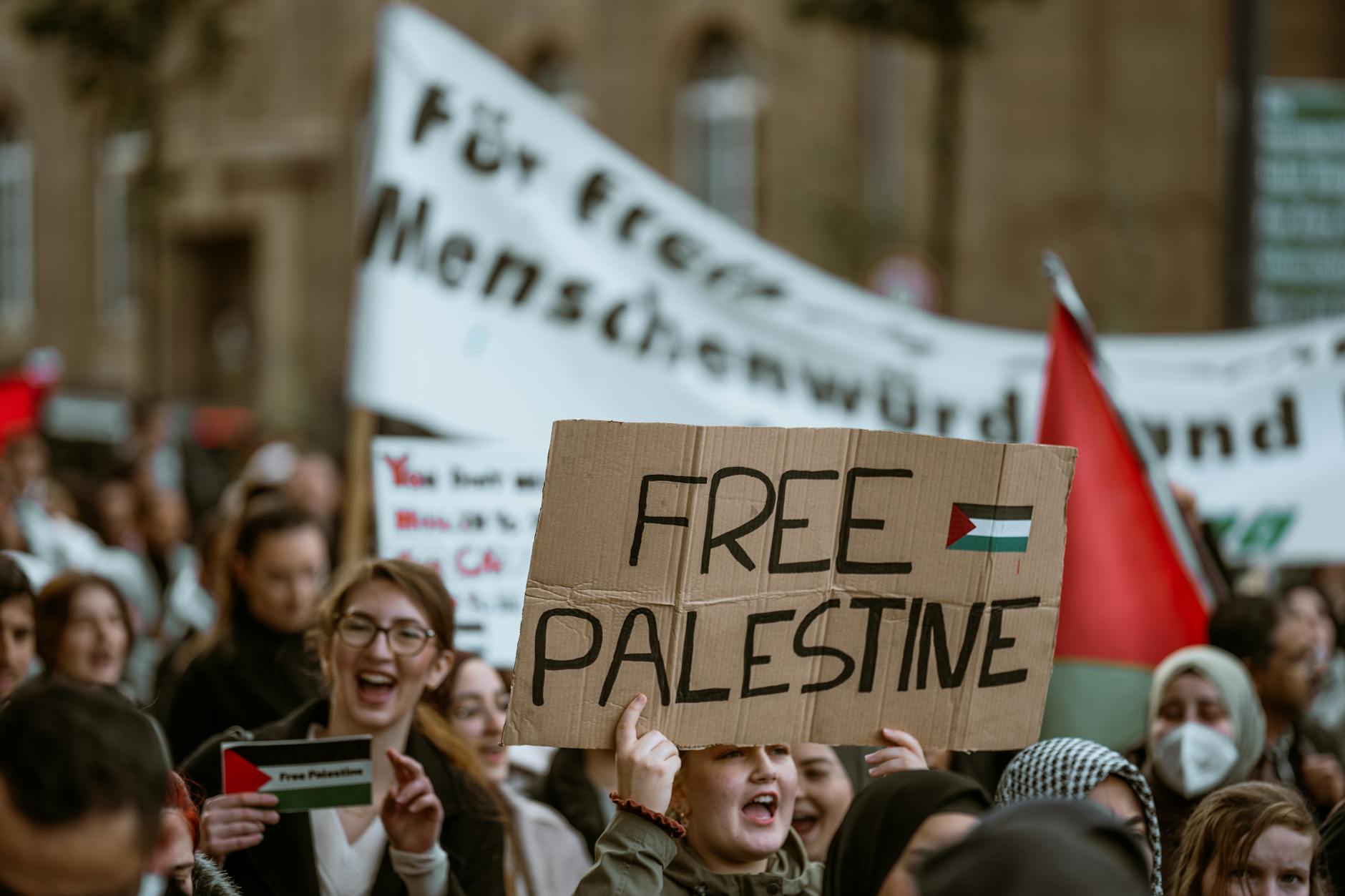 Diverse crowd at political campaign rally with American flags