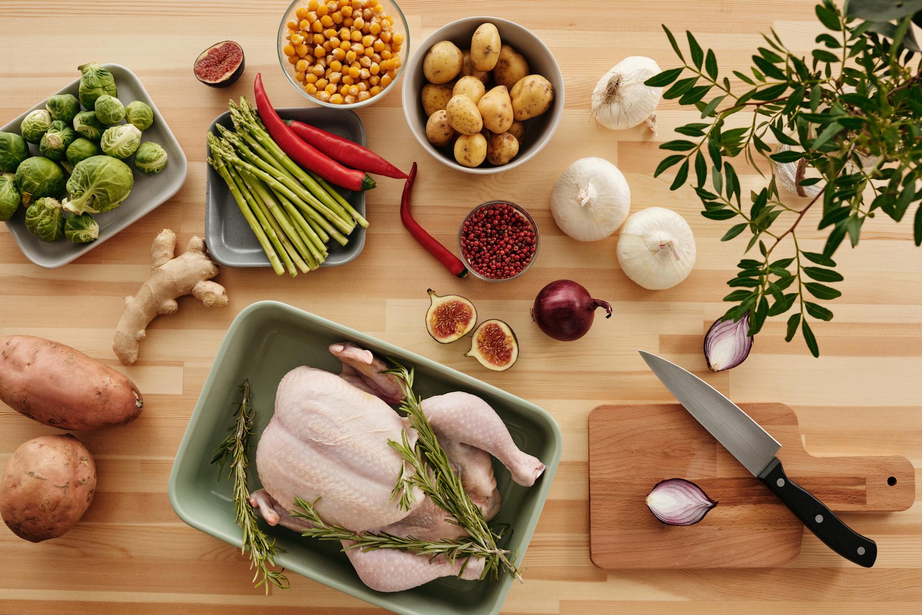 Fresh vegetables and ingredients arranged for meal preparation on kitchen counter