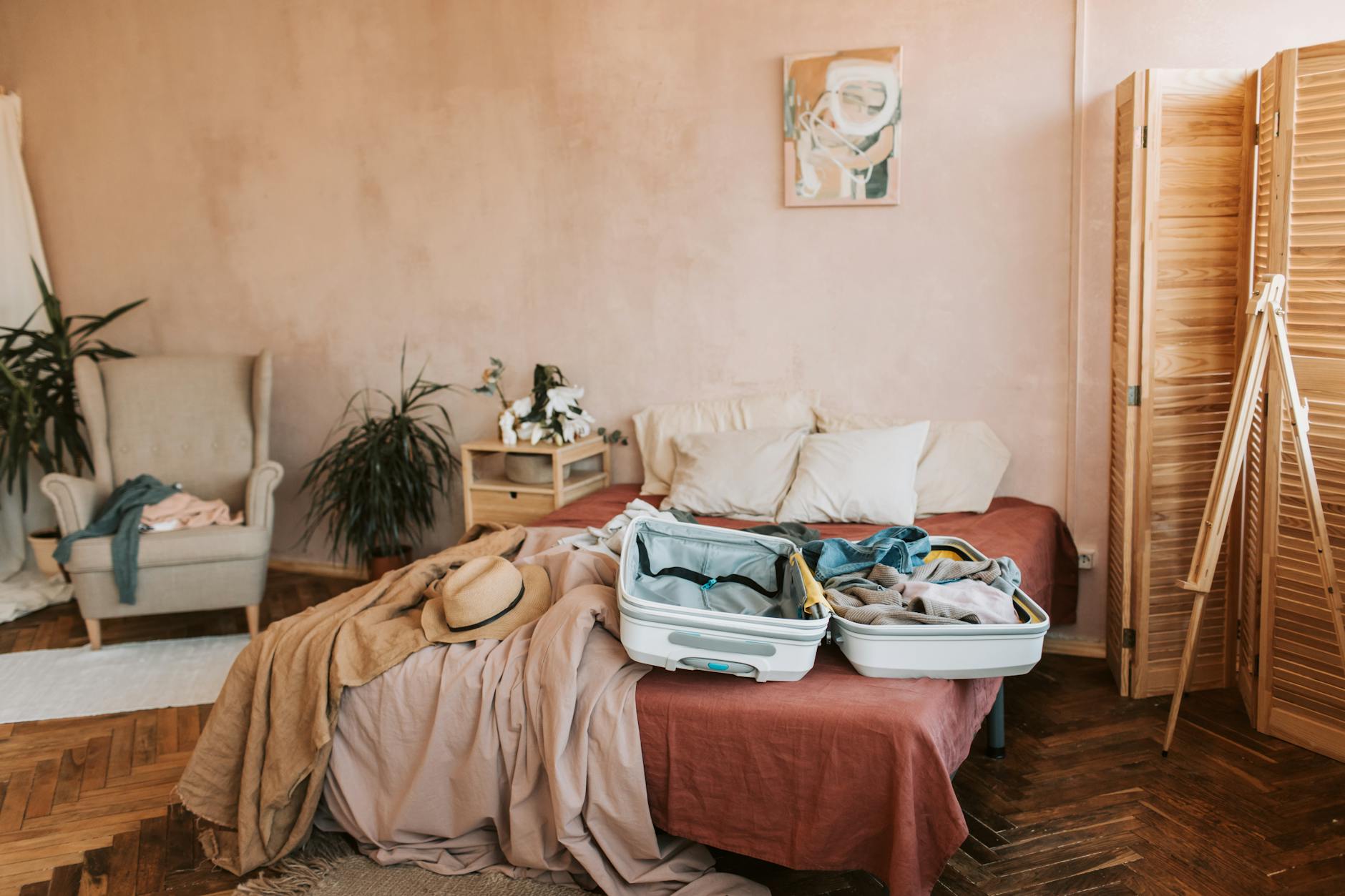Travel suitcase on hotel bed in clean, well-appointed guest room