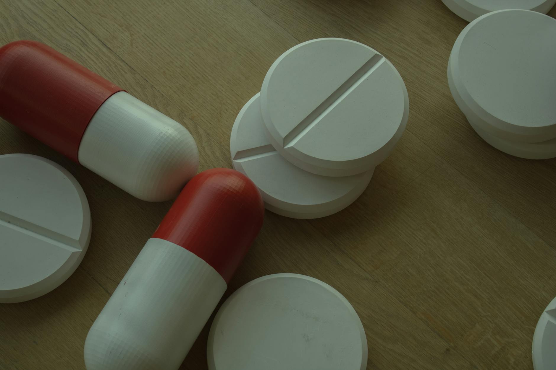 Various pharmaceutical pills and medications arranged on white surface