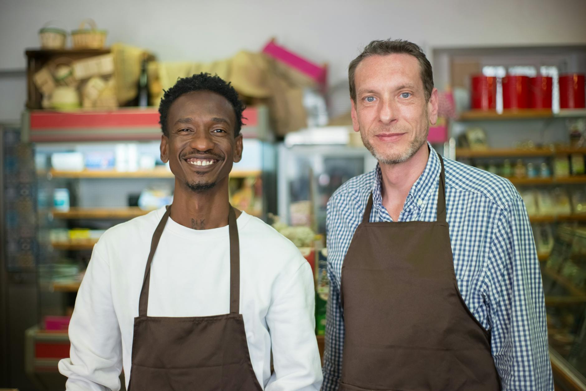 Friendly retail worker assisting customer at store checkout counter