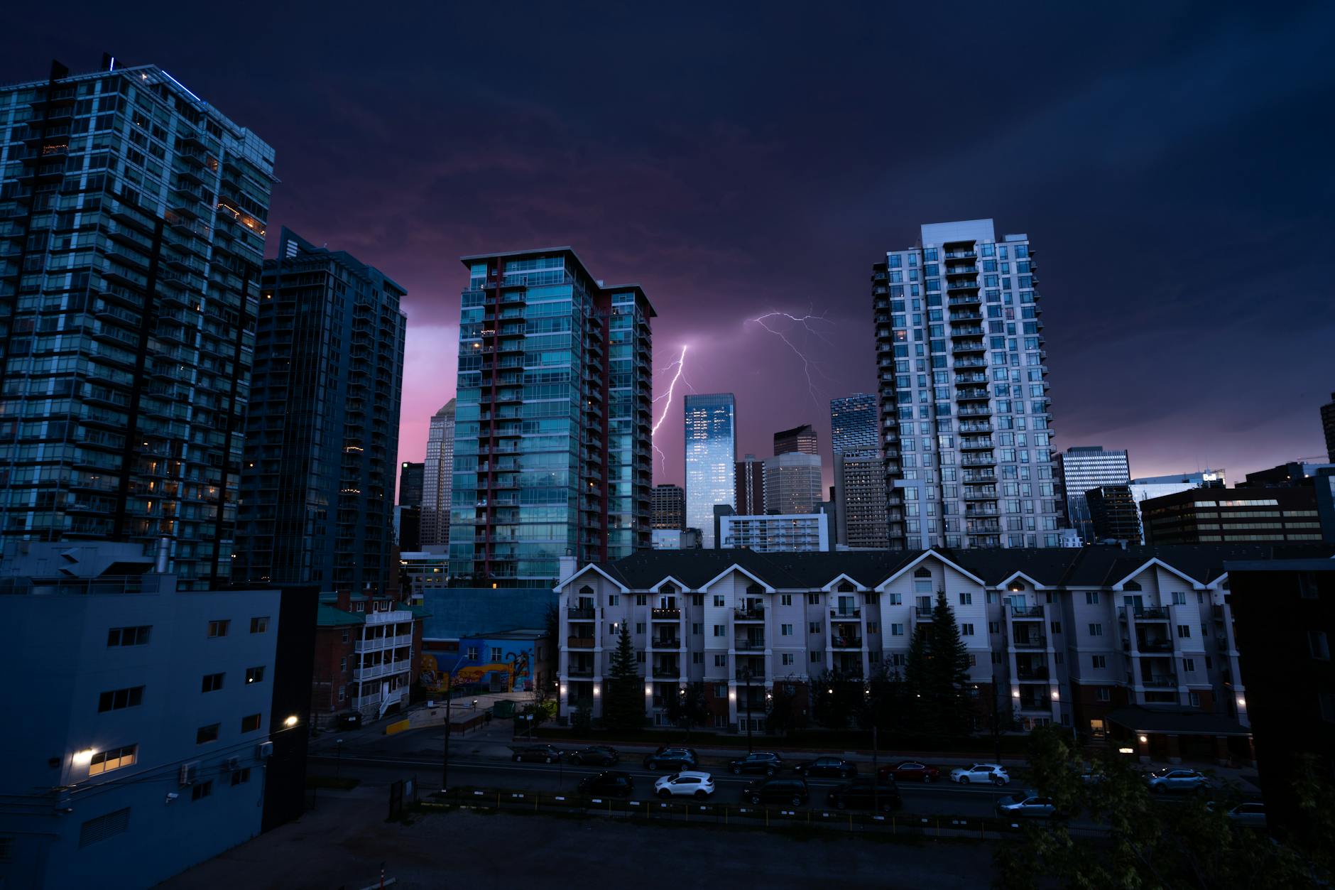 Dark storm clouds gathering over urban skyline showing weather patterns affecting real estate markets