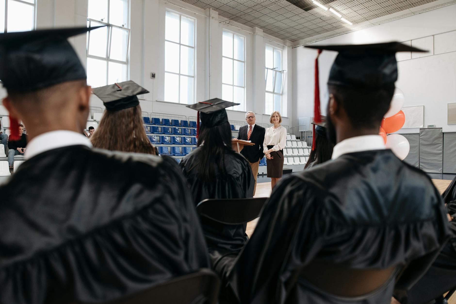 University graduation ceremony with students in caps and gowns celebrating commencement