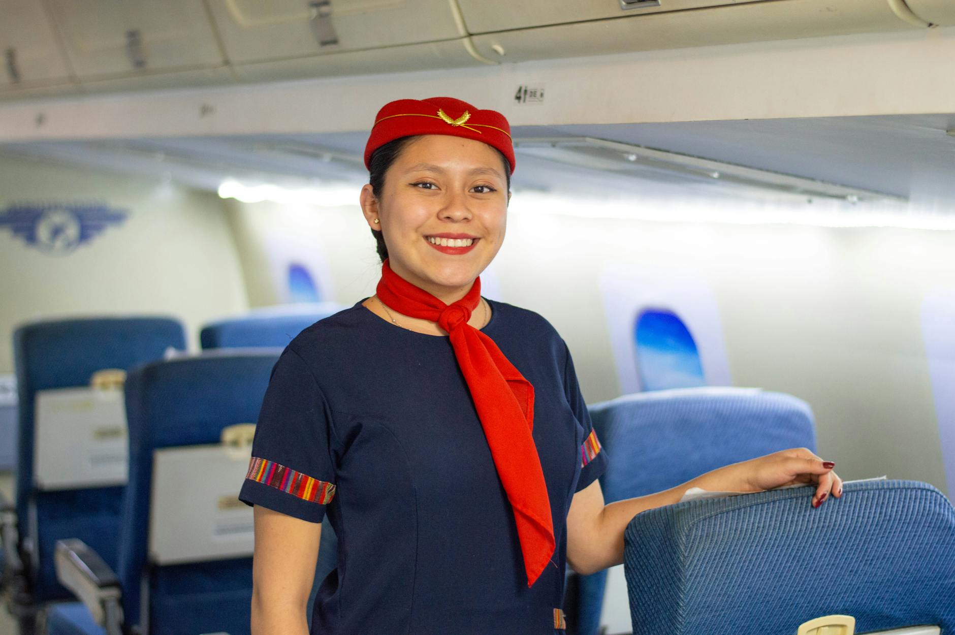 Flight attendant serving passengers in aircraft cabin during flight