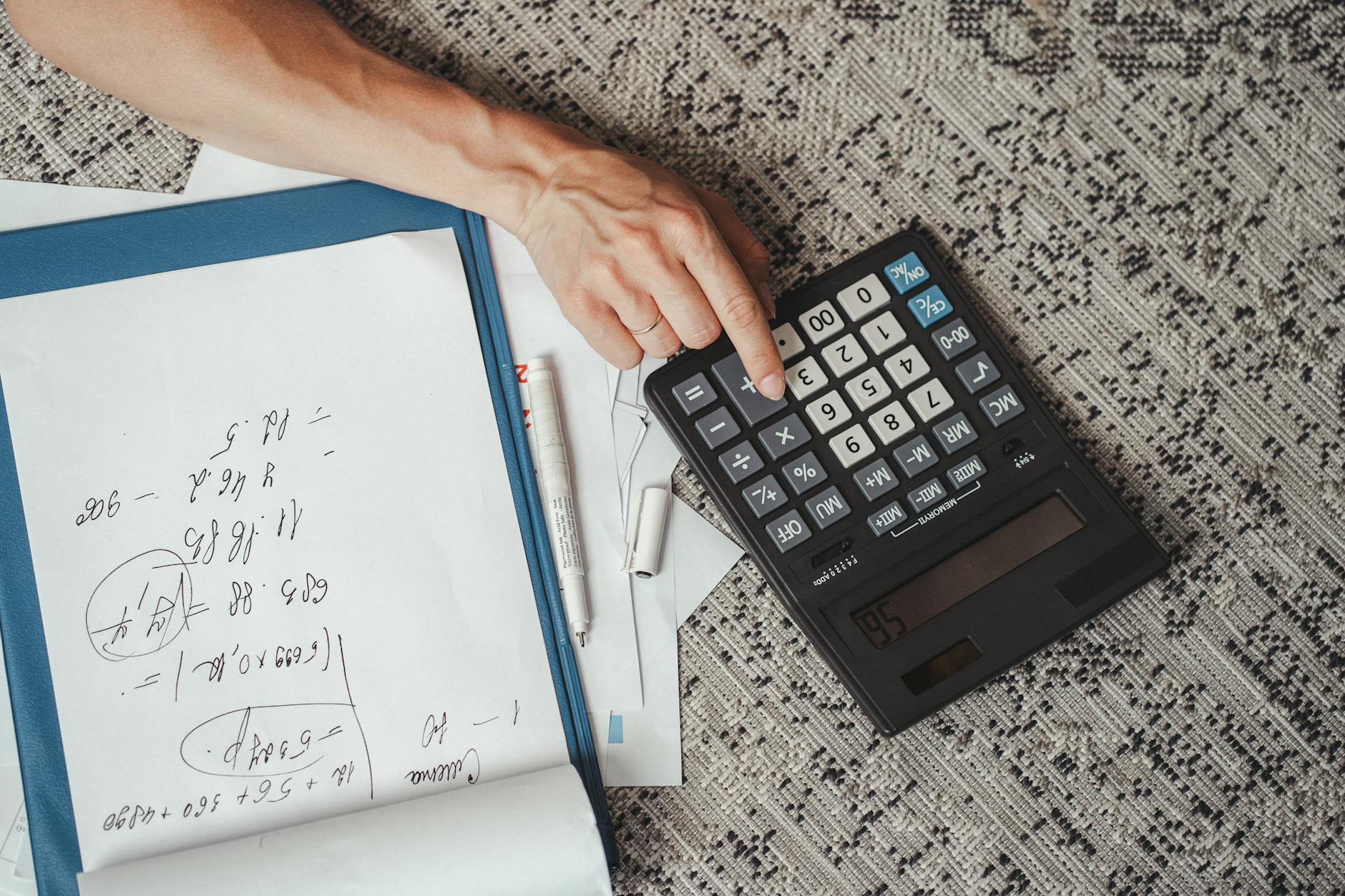Calculator and financial documents for mortgage planning and budgeting