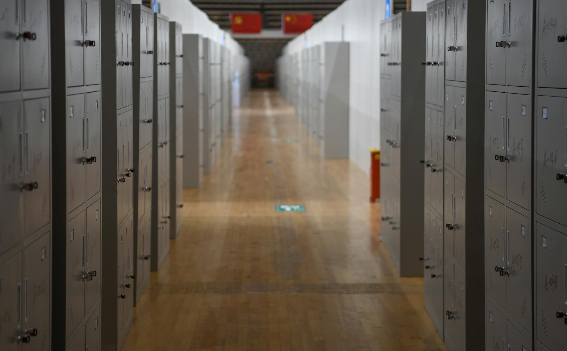 Empty school hallway with lockers lining both walls, symbolizing educational transitions