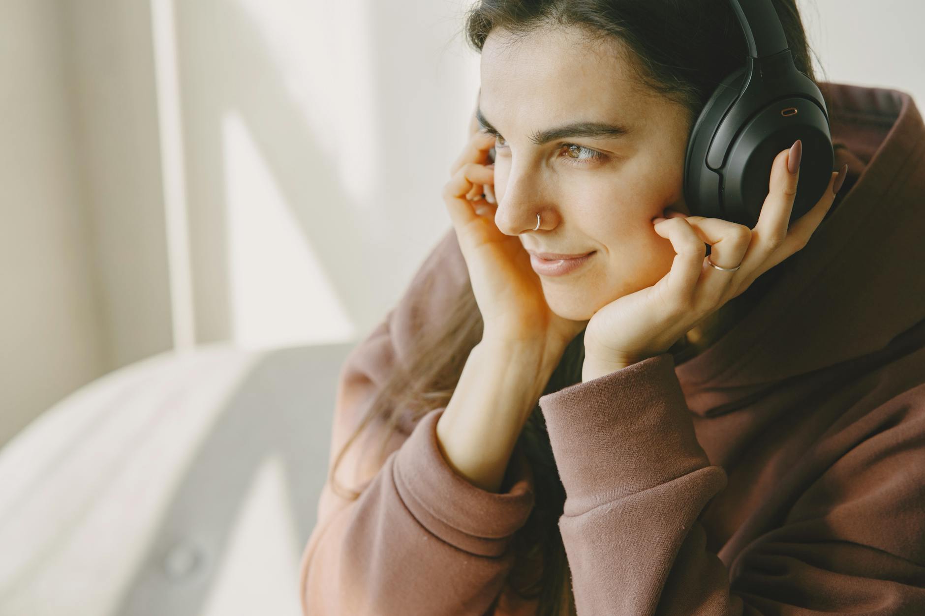 Person wearing headphones listening to audio content, representing engaged podcast audience