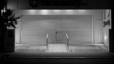 Empty retail pharmacy interior with vacant shelves and closed counter