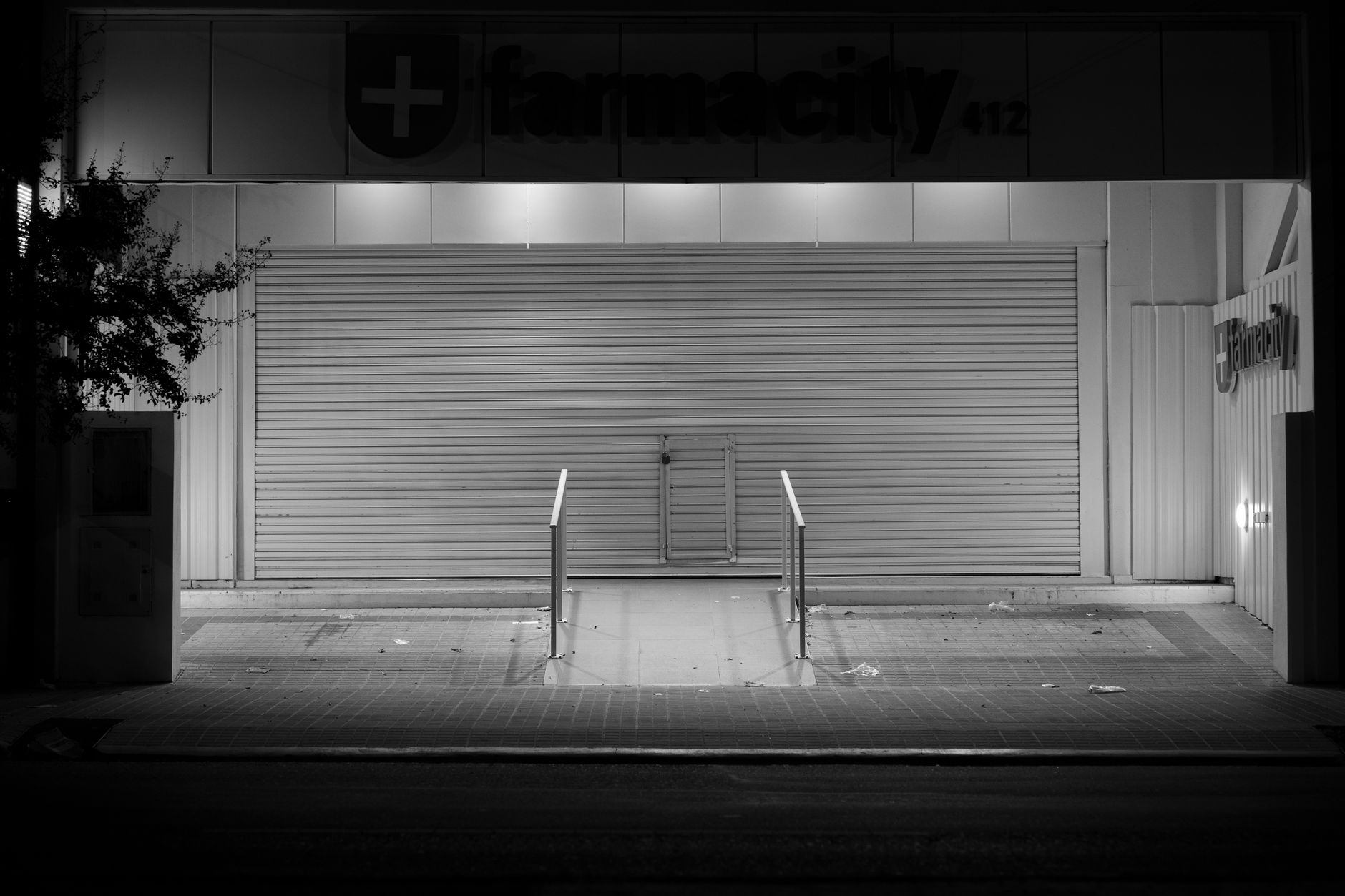 Empty retail pharmacy interior with vacant shelves and closed counter