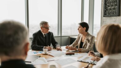 Business professionals reviewing financial documents at a corporate meeting table