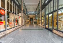 Empty mall interior with vacant storefronts and minimal foot traffic