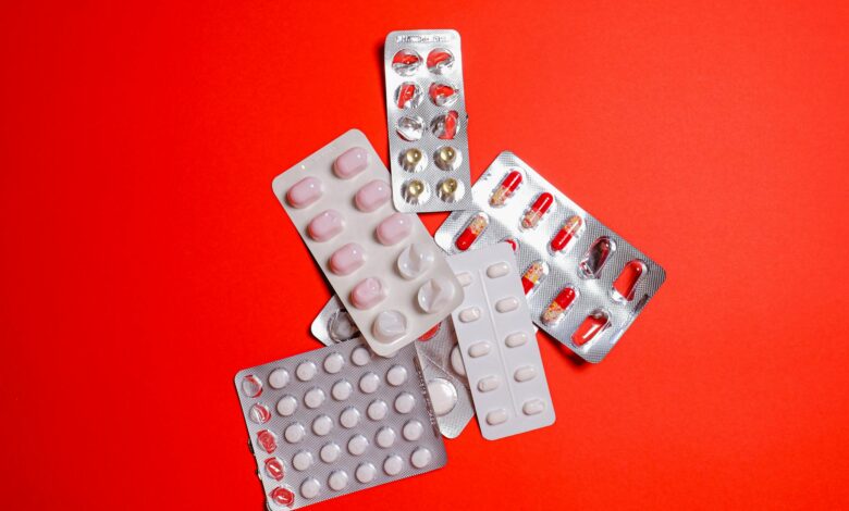 Rows of prescription medications on pharmacy shelves representing specialty drug distribution