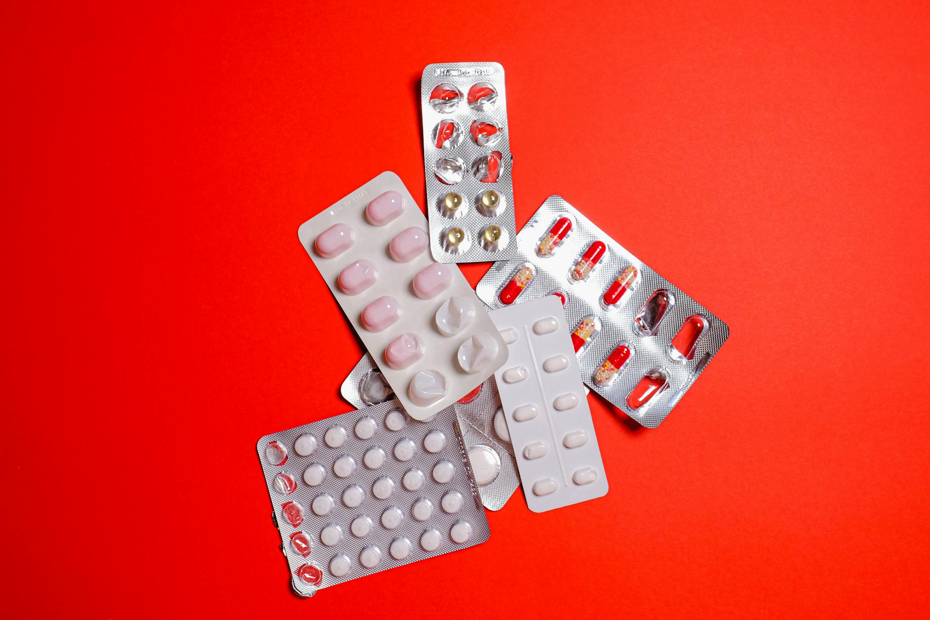 Rows of prescription medications on pharmacy shelves representing specialty drug distribution