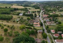 Aerial view of rural farmland with crop rows stretching to the horizon