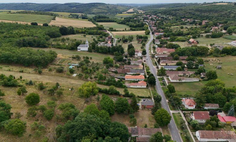 Aerial view of rural farmland with crop rows stretching to the horizon