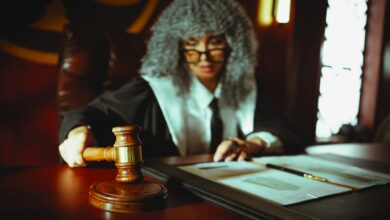 Judge's gavel on wooden desk in courtroom setting