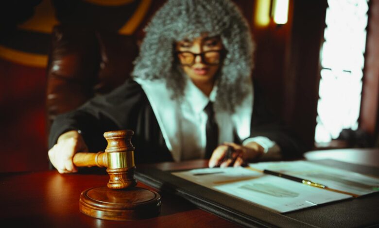Judge's gavel on wooden desk in courtroom setting
