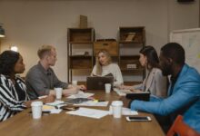 Professional business meeting in modern office setting with people collaborating