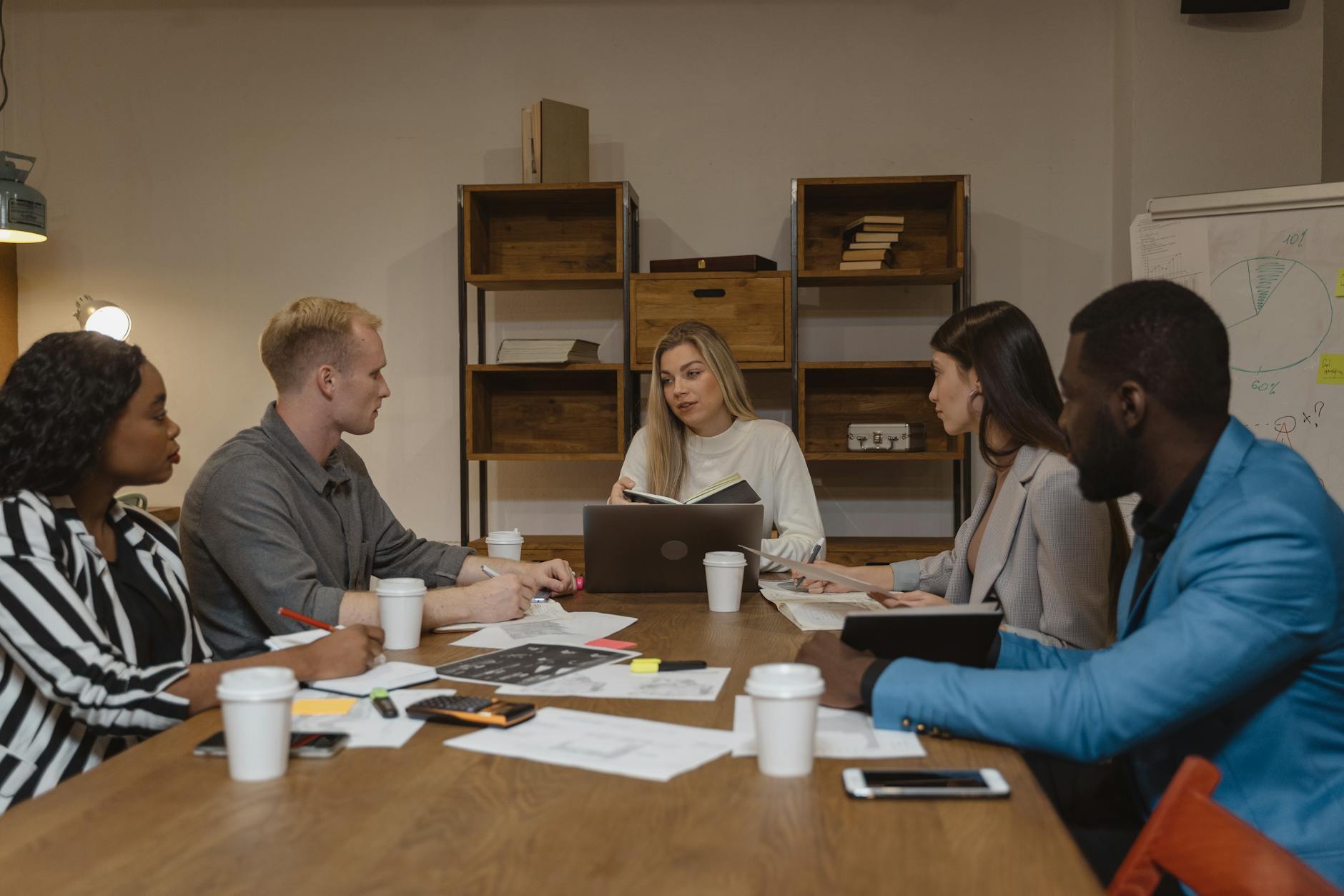 Professional business meeting in modern office setting with people collaborating