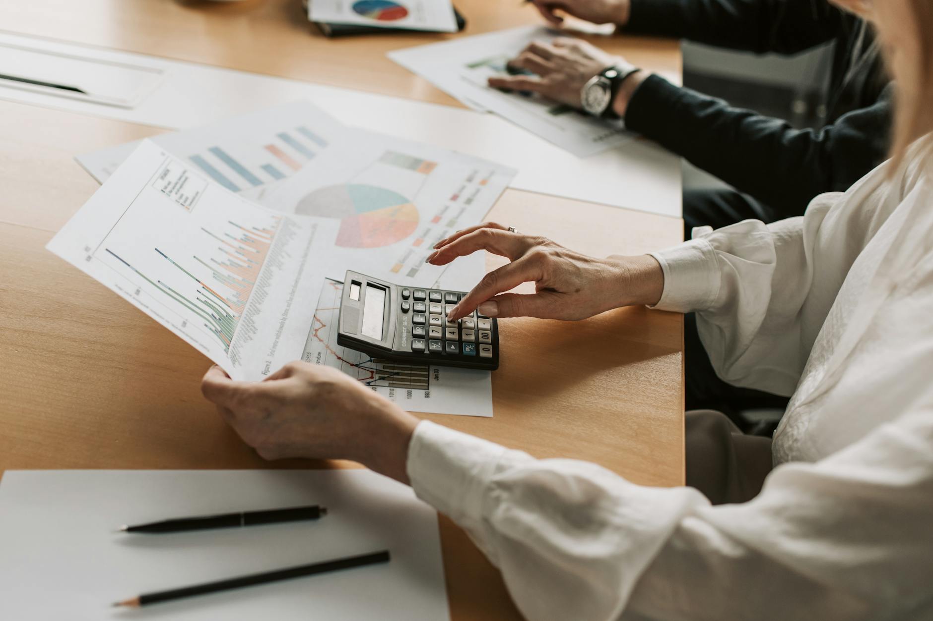 Business professionals reviewing investment documents at a conference table
