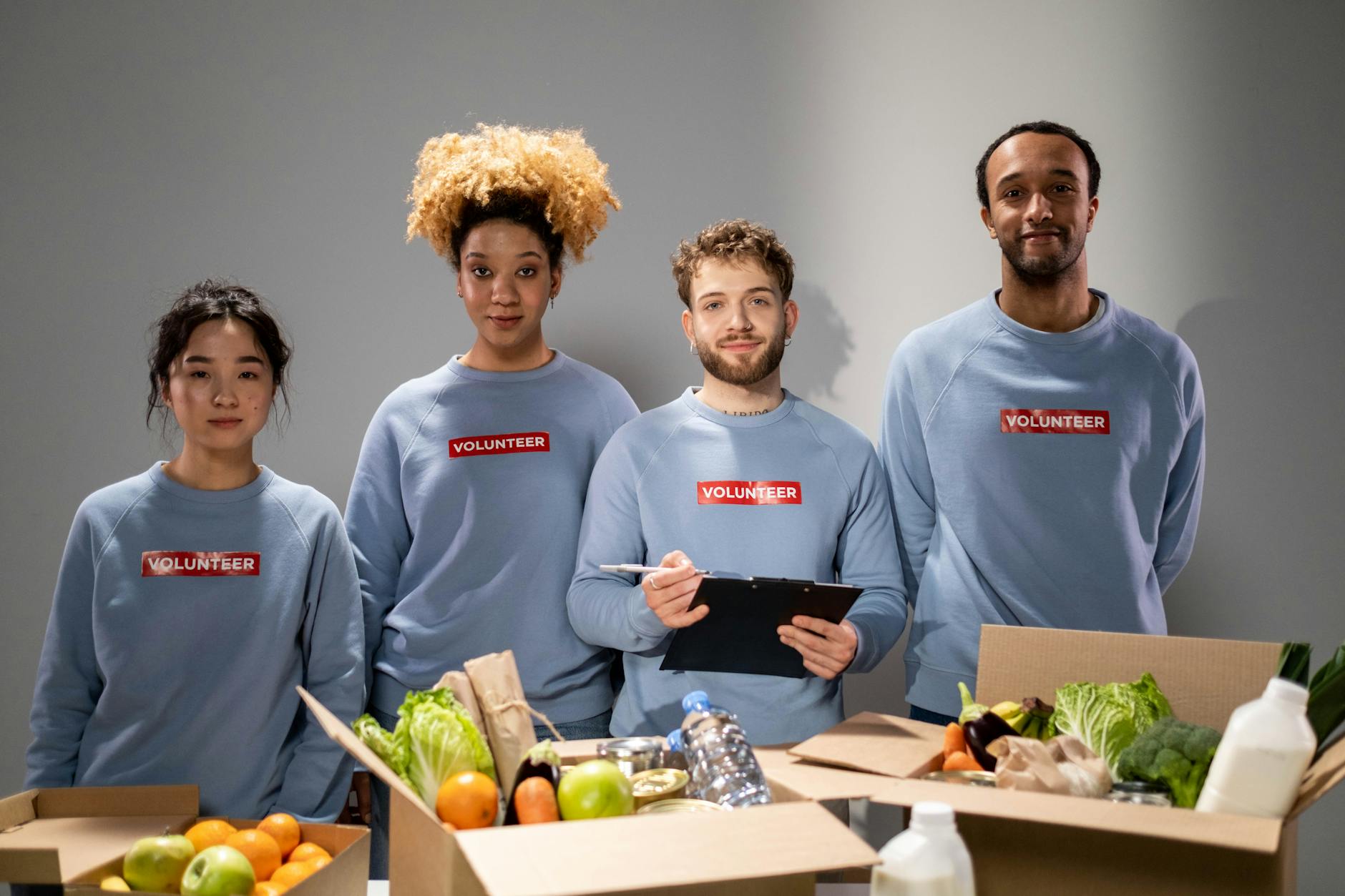 Volunteers sorting food donations inside a regional food bank facility