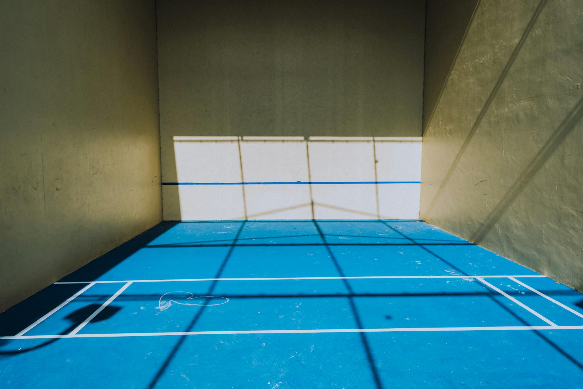 Indoor pickleball courts with players competing inside a large facility
