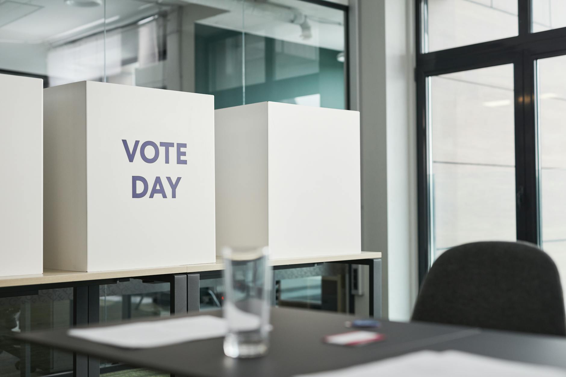 Person casting ballot in private voting booth during election