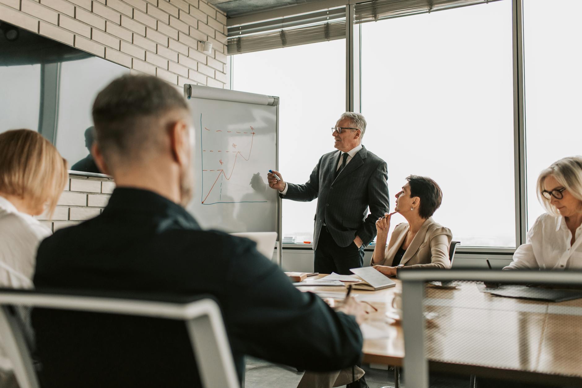 Corporate executives meeting in a boardroom discussing strategic business decisions