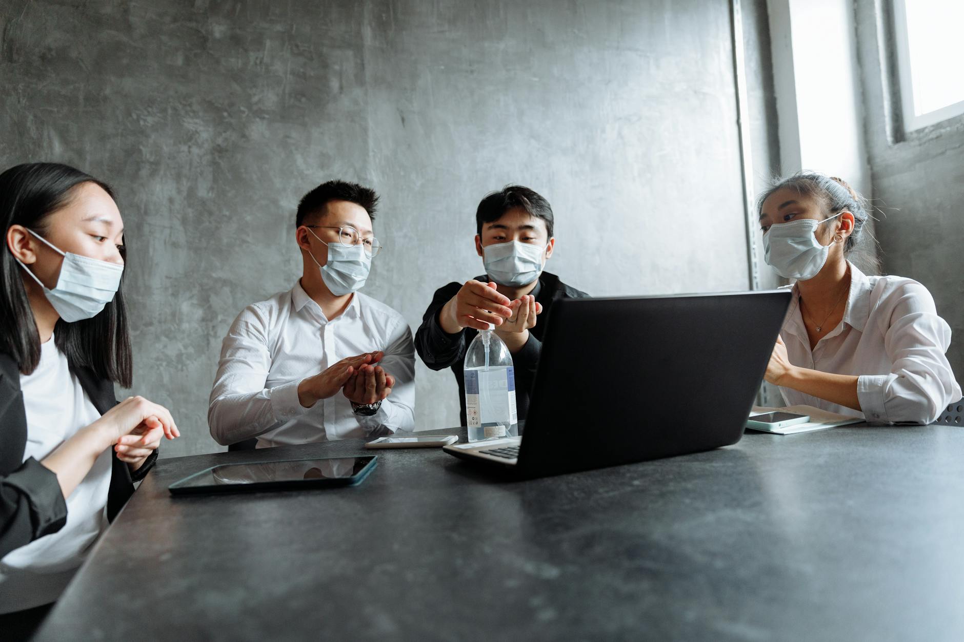 Business professionals reviewing documents in a meeting room in a healthcare setting