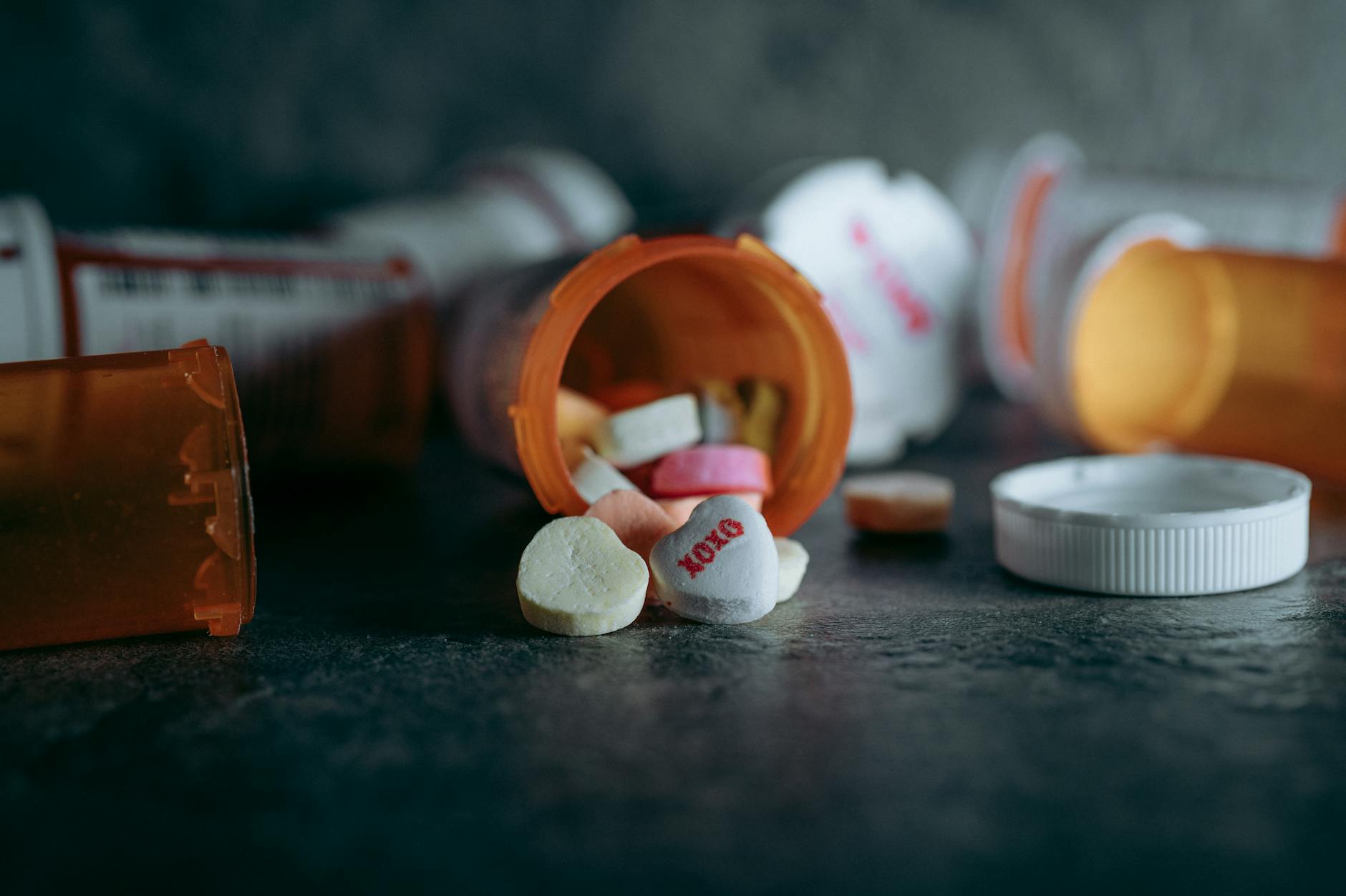 Row of prescription medication bottles on a pharmacy shelf