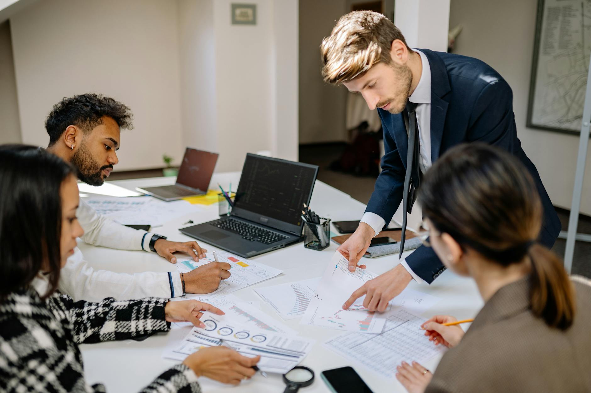 Two professionals reviewing financial documents during a wealth management consultation