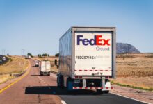 Multiple semi-trucks driving on a highway representing the freight transportation industry