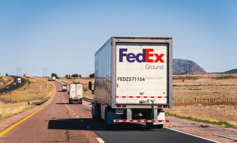 Multiple semi-trucks driving on a highway representing the freight transportation industry
