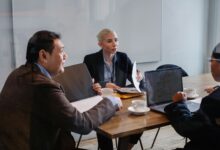Creative professionals gathered around a conference table in an advertising agency office