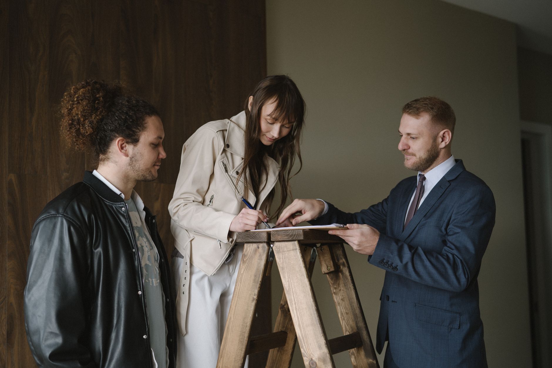 Two professionals reviewing documents at a real estate closing table