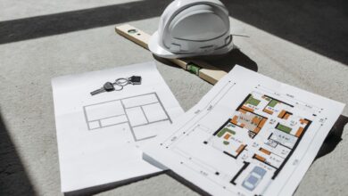 Architectural blueprints spread across a drafting table in a design studio