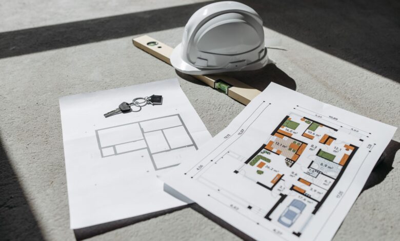 Architectural blueprints spread across a drafting table in a design studio