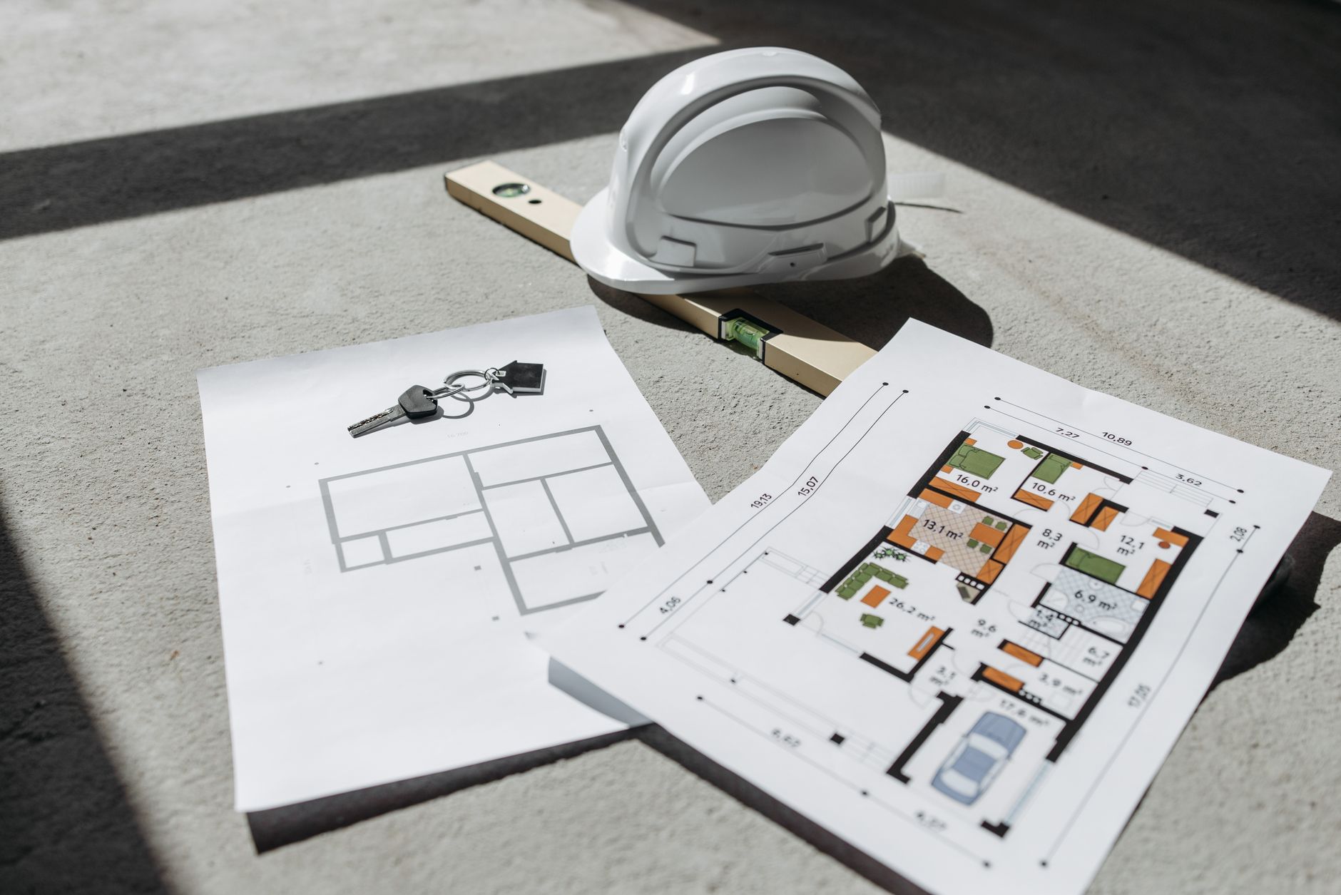 Architectural blueprints spread across a drafting table in a design studio
