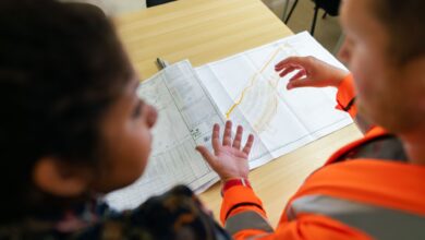Engineers reviewing technical blueprints at a regional engineering firm office
