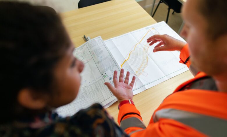 Engineers reviewing technical blueprints at a regional engineering firm office