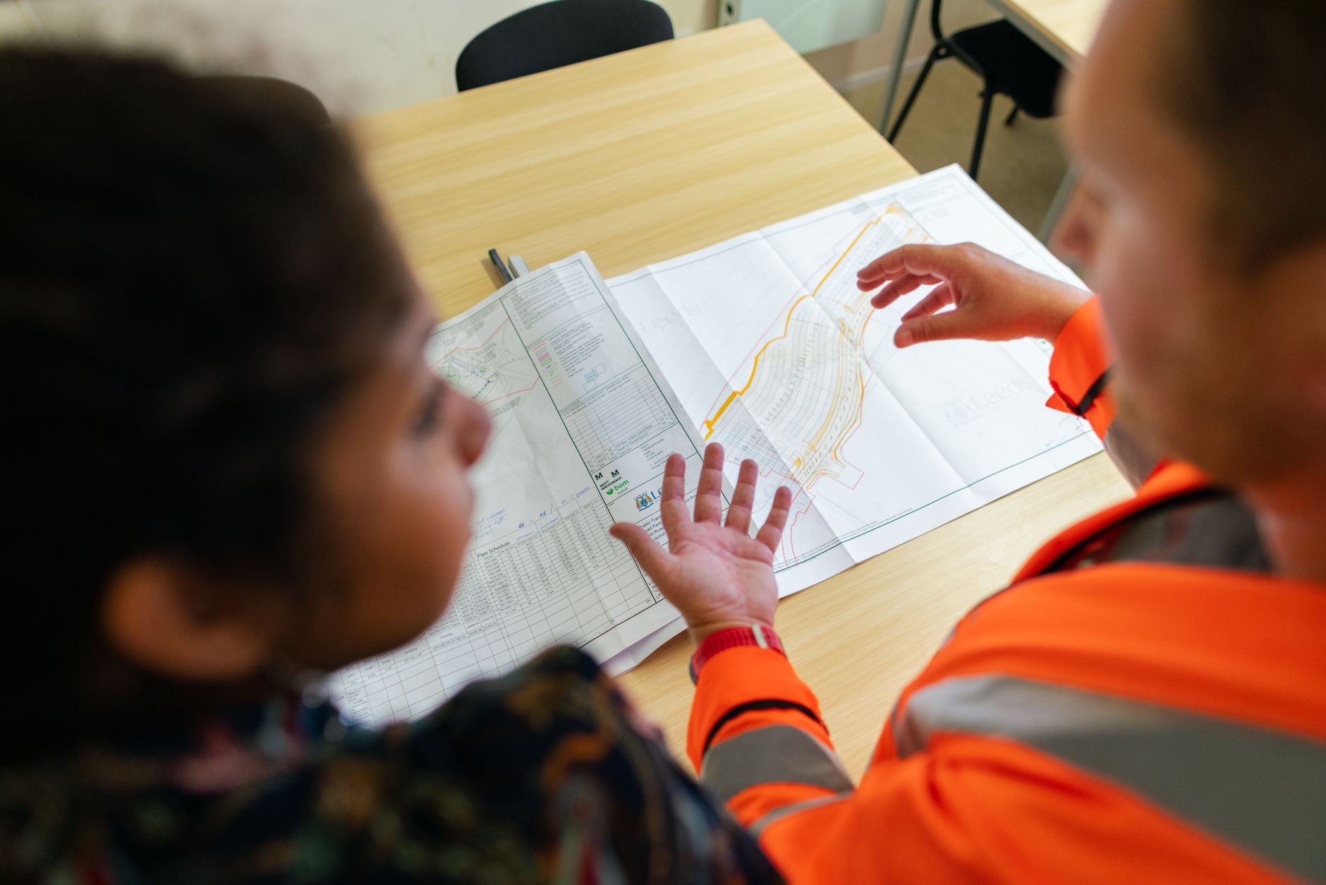 Engineers reviewing technical blueprints at a regional engineering firm office
