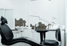 Modern dental practice waiting room with reception desk and chairs