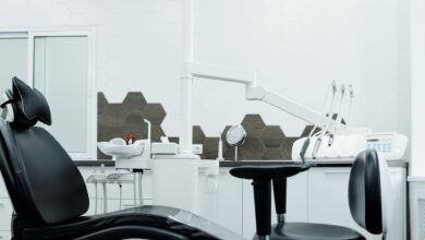 Modern dental practice waiting room with reception desk and chairs
