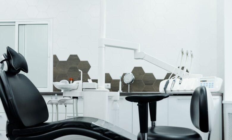 Modern dental practice waiting room with reception desk and chairs