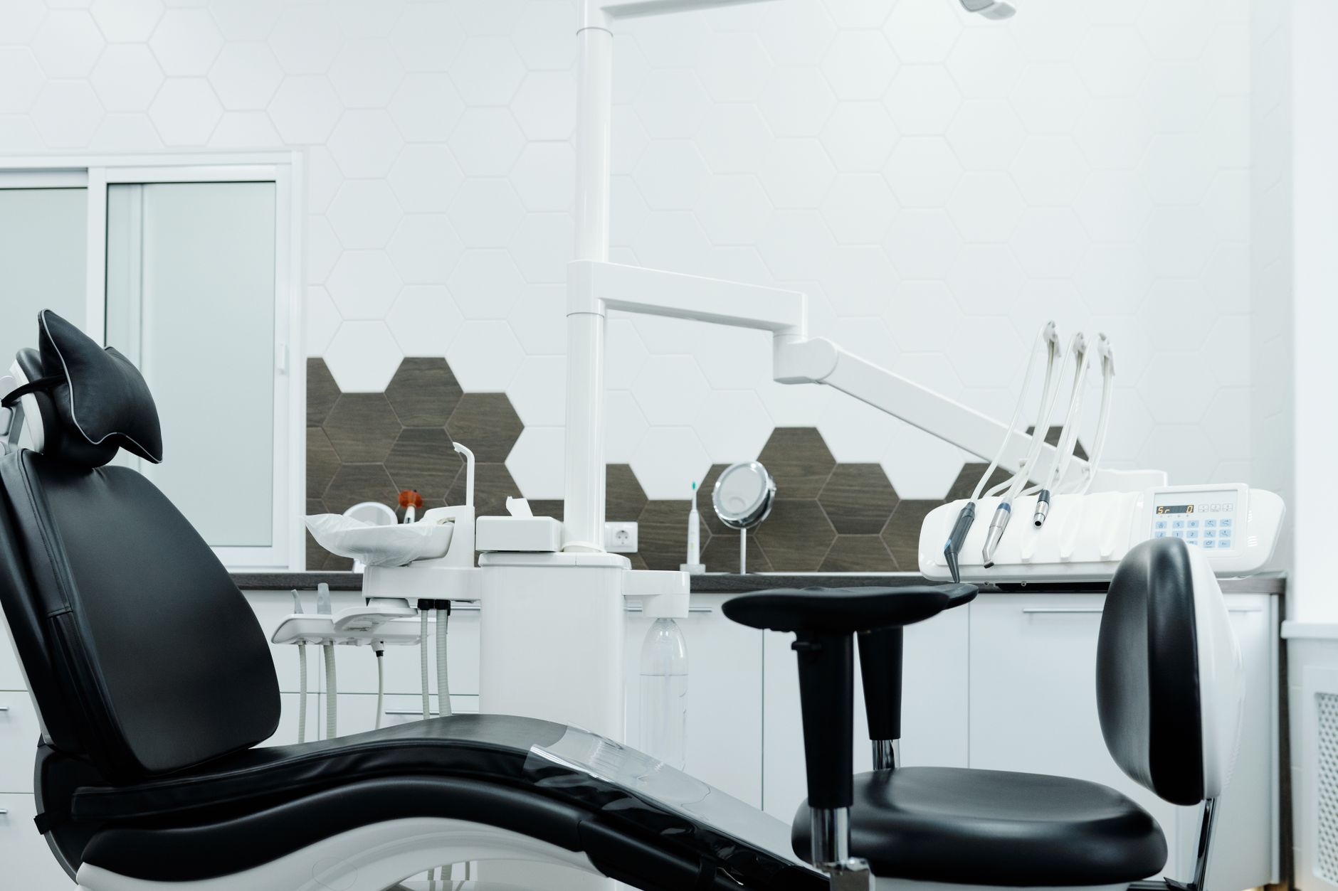 Modern dental practice waiting room with reception desk and chairs