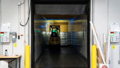 Workers moving packages inside a large regional logistics warehouse