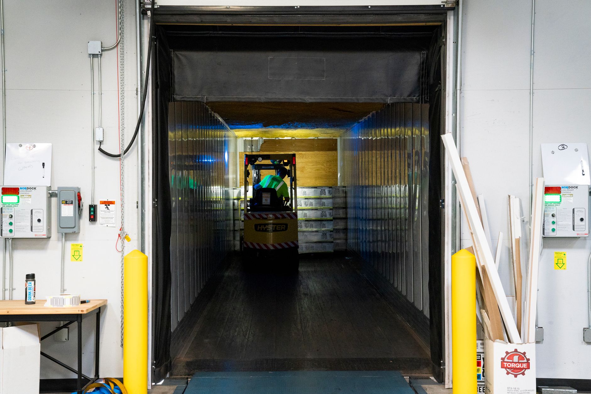Workers moving packages inside a large regional logistics warehouse