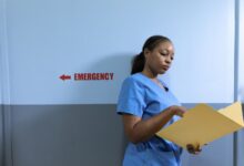 A nurse walking through a hospital hallway in scrubs, representing healthcare staffing