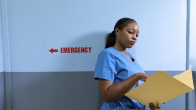 A nurse walking through a hospital hallway in scrubs, representing healthcare staffing